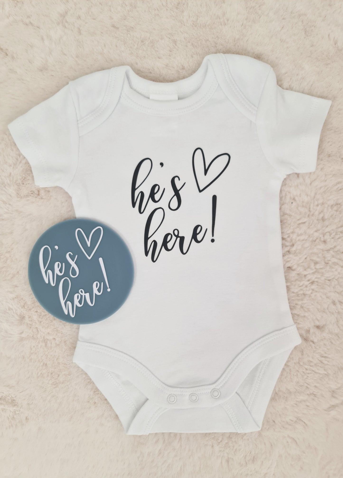 "He's here" baby announcement onesie