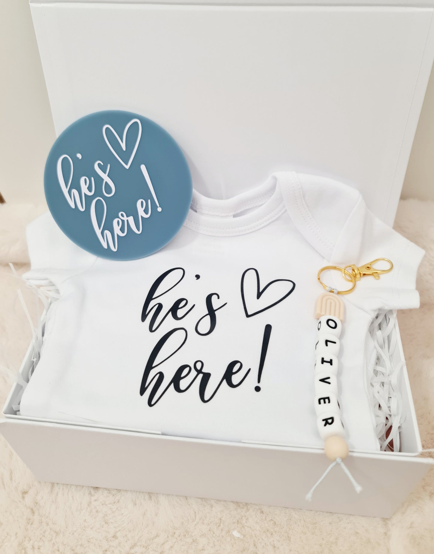"He's here" baby announcement onesie