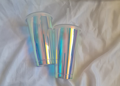 Iridescent cylindrical objects on a white fabric background