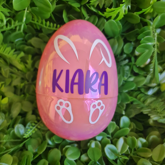 Pink Easter egg with 'KIARA' on a green leaf background