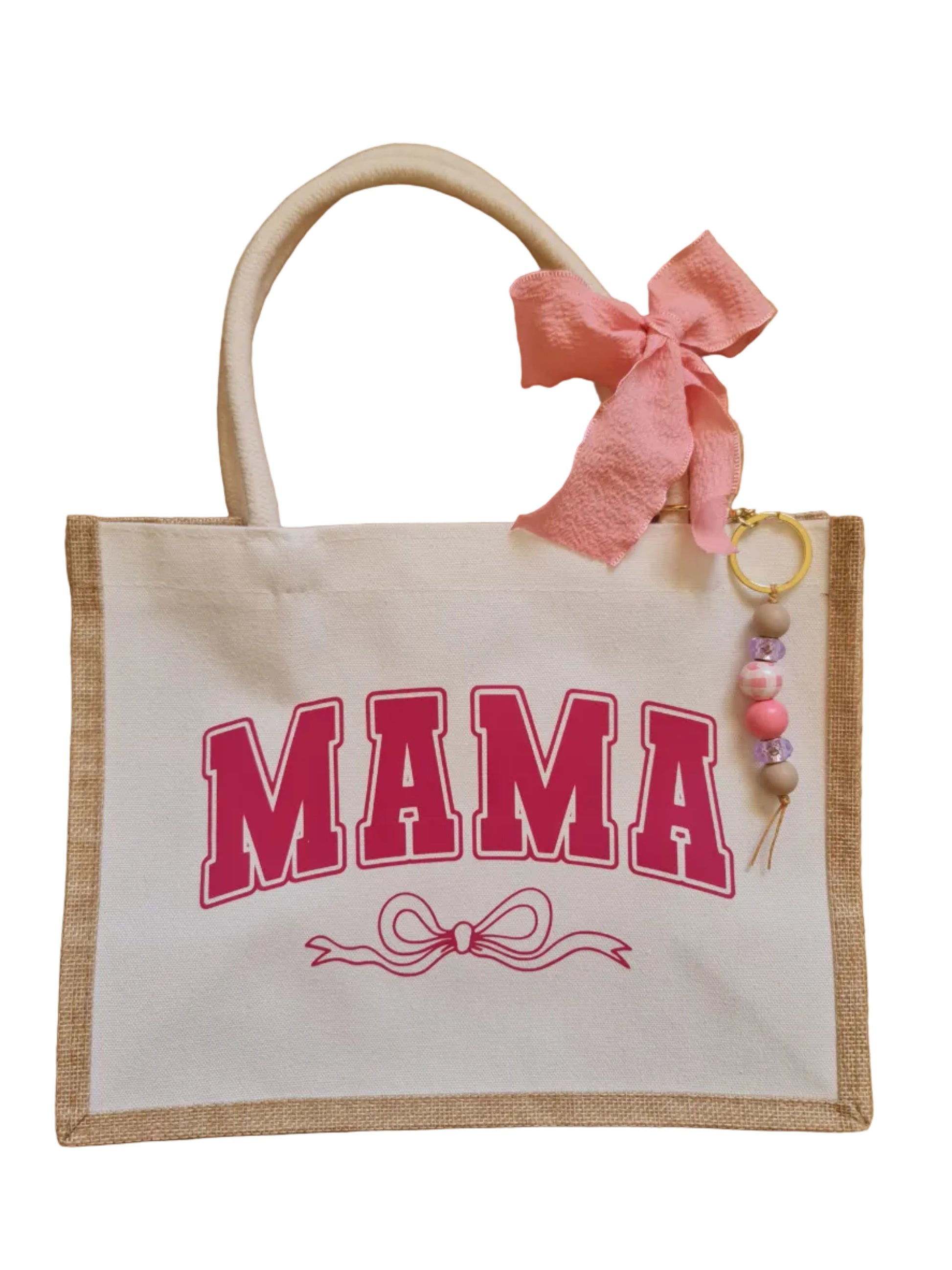 Tote bag with 'MAMA' text and pink bow on a wooden surface