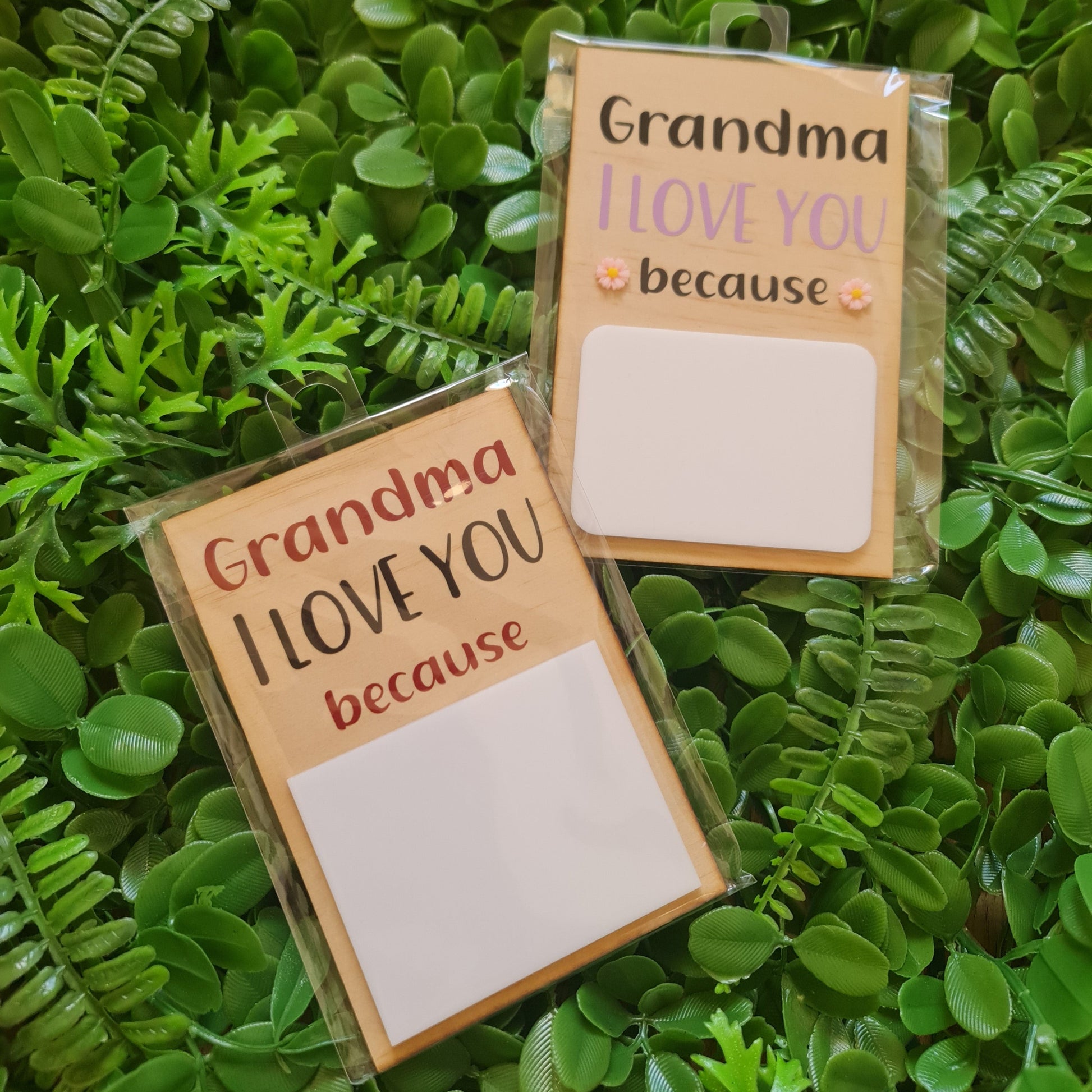 Two small rectangular cards with text on a green leafy background