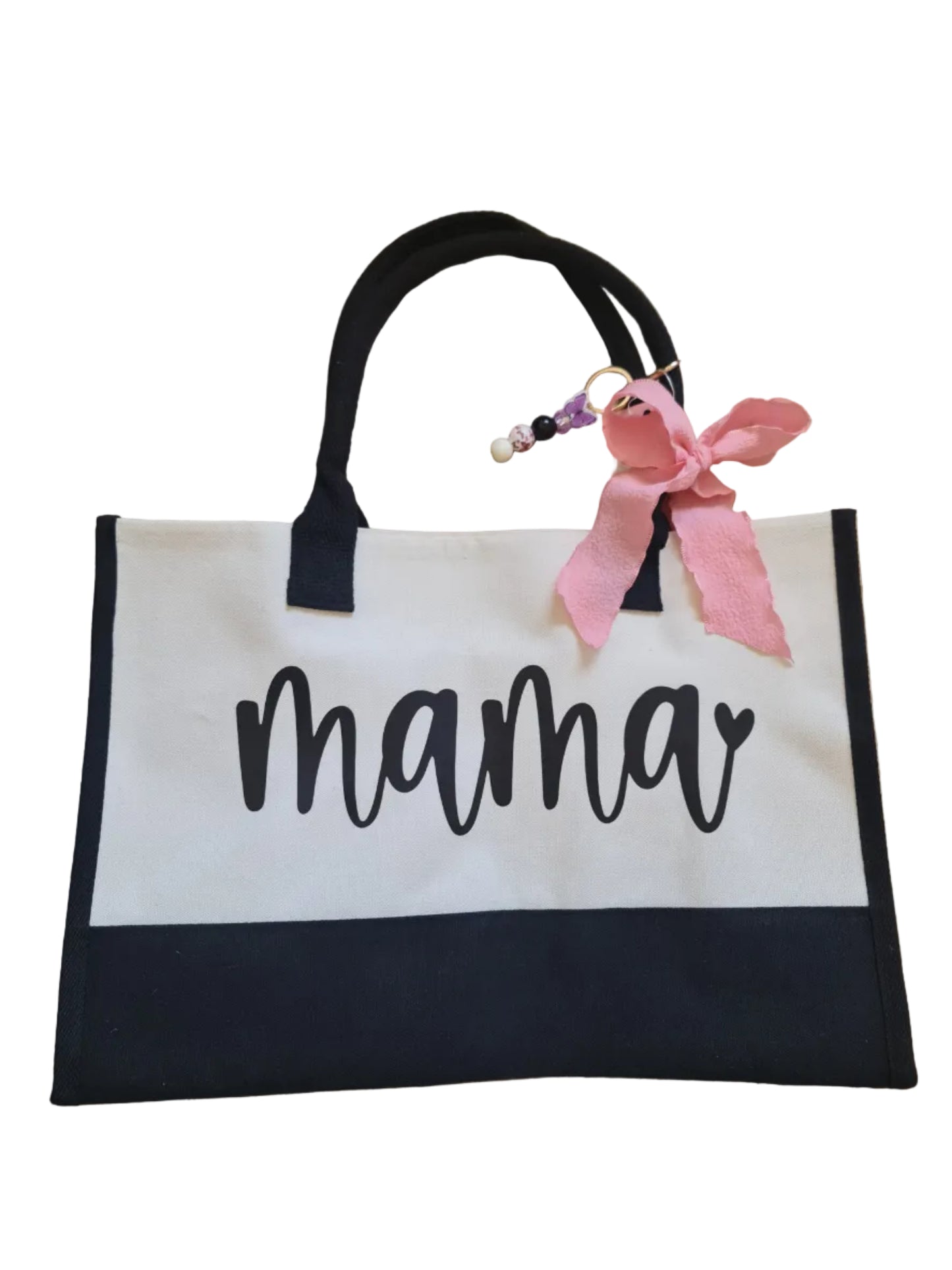 Tote bag with 'mama' text and pink bow on a wooden floor