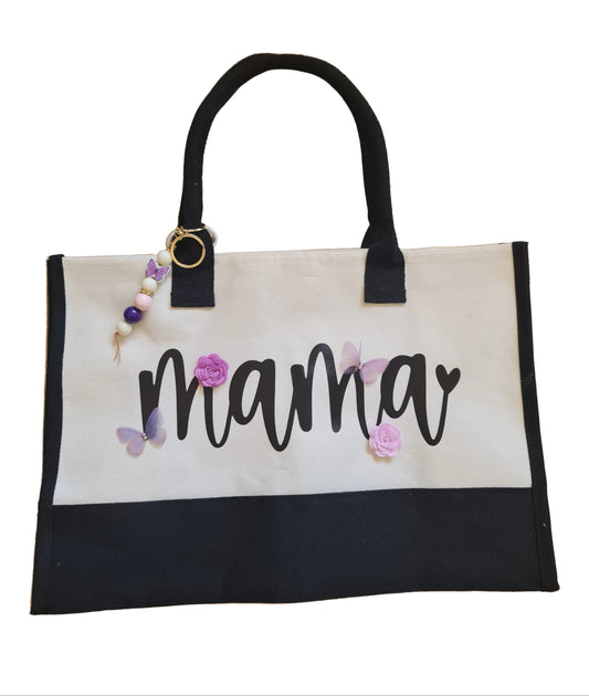 Tote bag with 'mama' text and floral decorations on a wooden floor