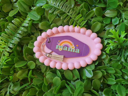 Pink keychain with 'mama' text on a green leafy background