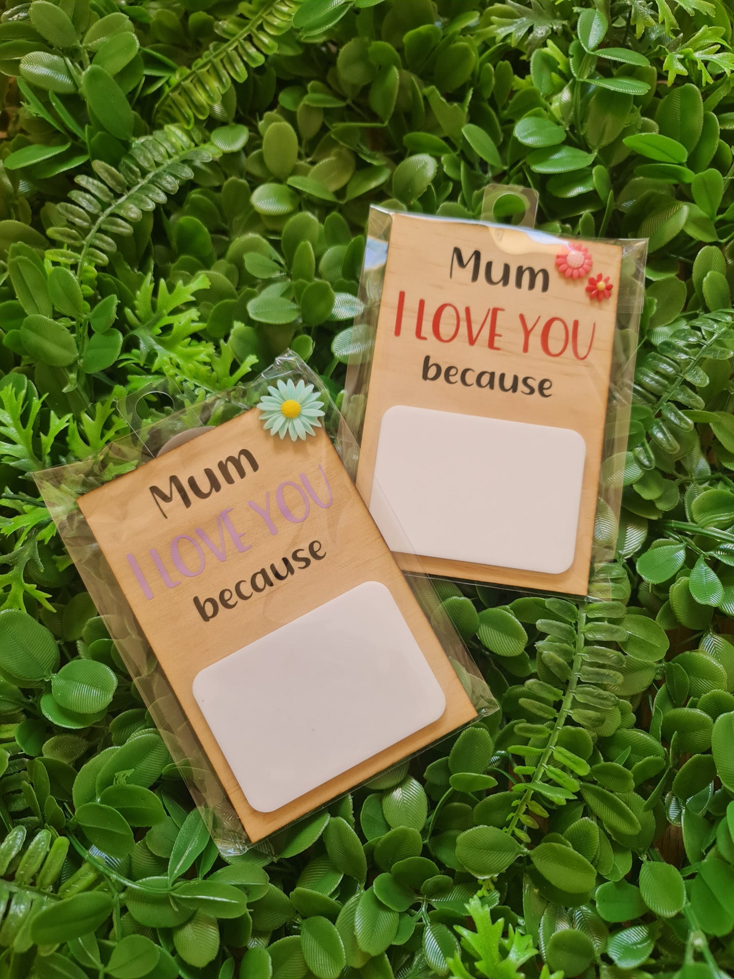 Two small cardboard boxes with 'Mum I love you because' text on a green leafy background