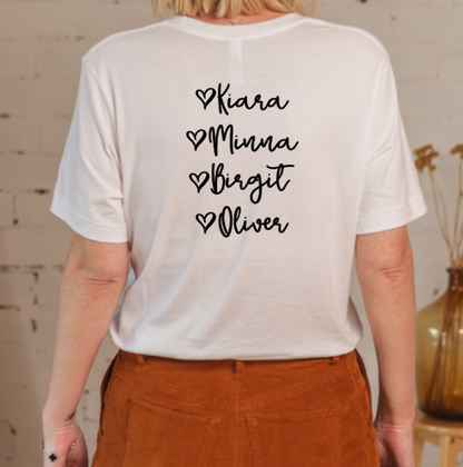 Person wearing a white t-shirt with names printed on the back against a neutral background
