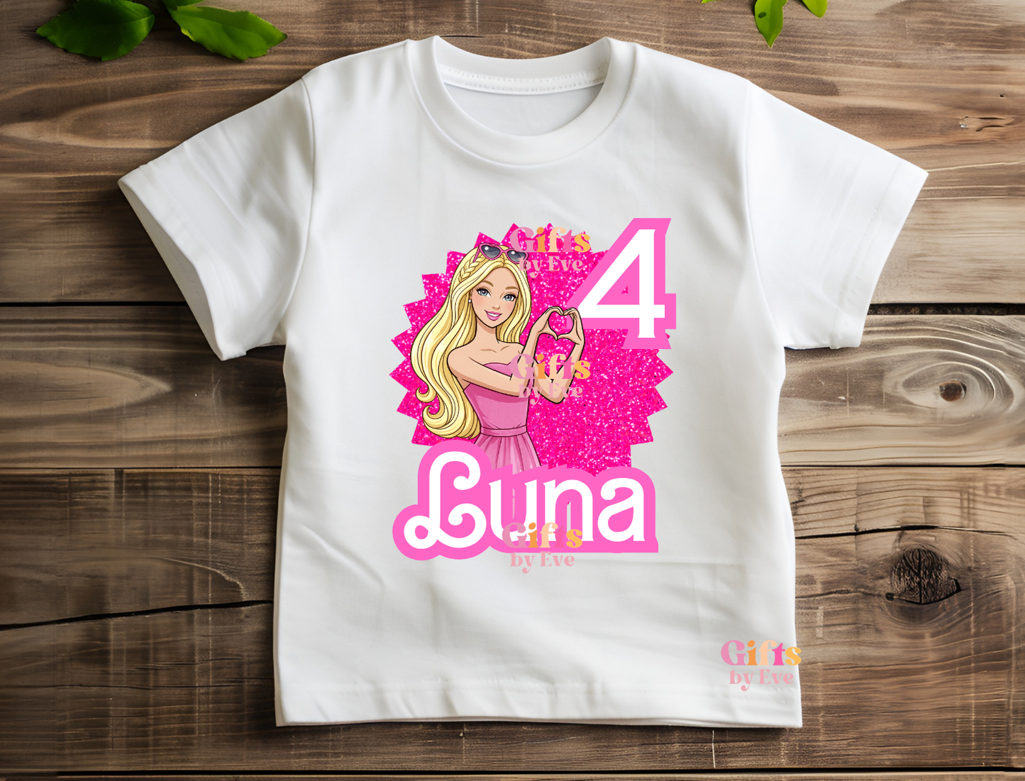 White t-shirt with a personalized design of a girl holding a heart, age 4, and name Luna on a wooden surface.