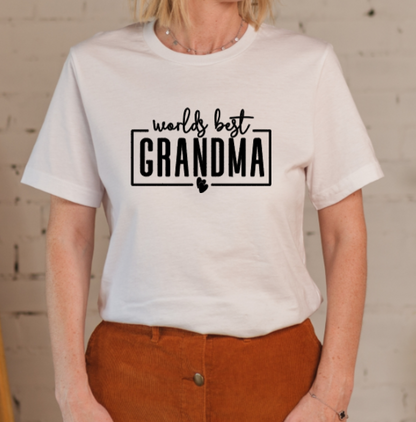 Person wearing a white t-shirt with 'worlds best grandma' text.