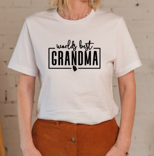 Person wearing a white t-shirt with 'worlds best grandma' text.