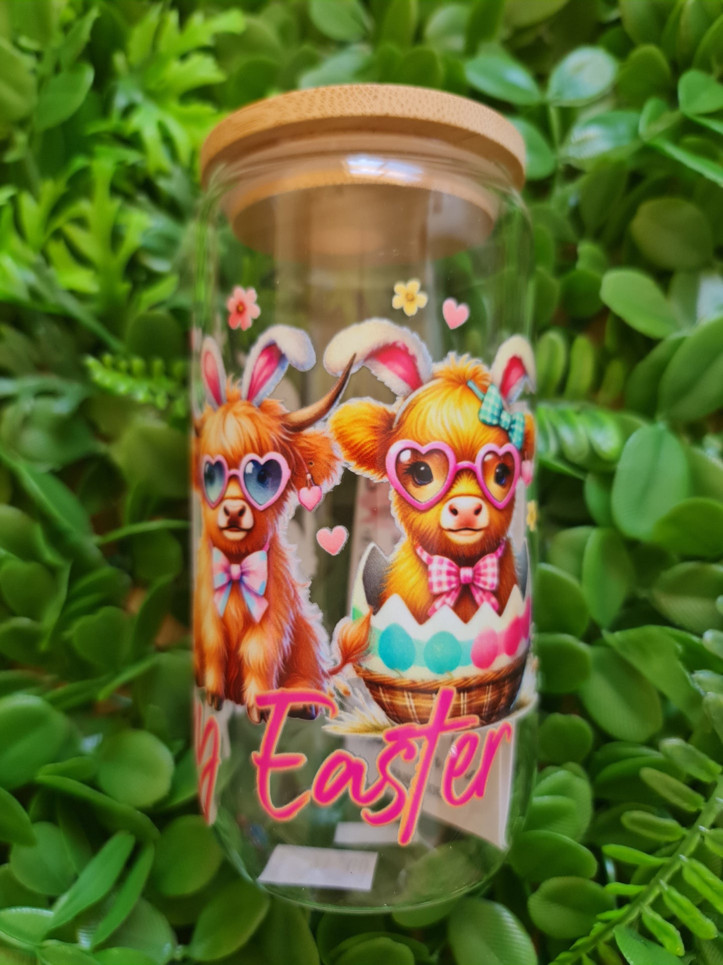 Clear glass mug with Easter-themed design of a bear and text on a green leaf background