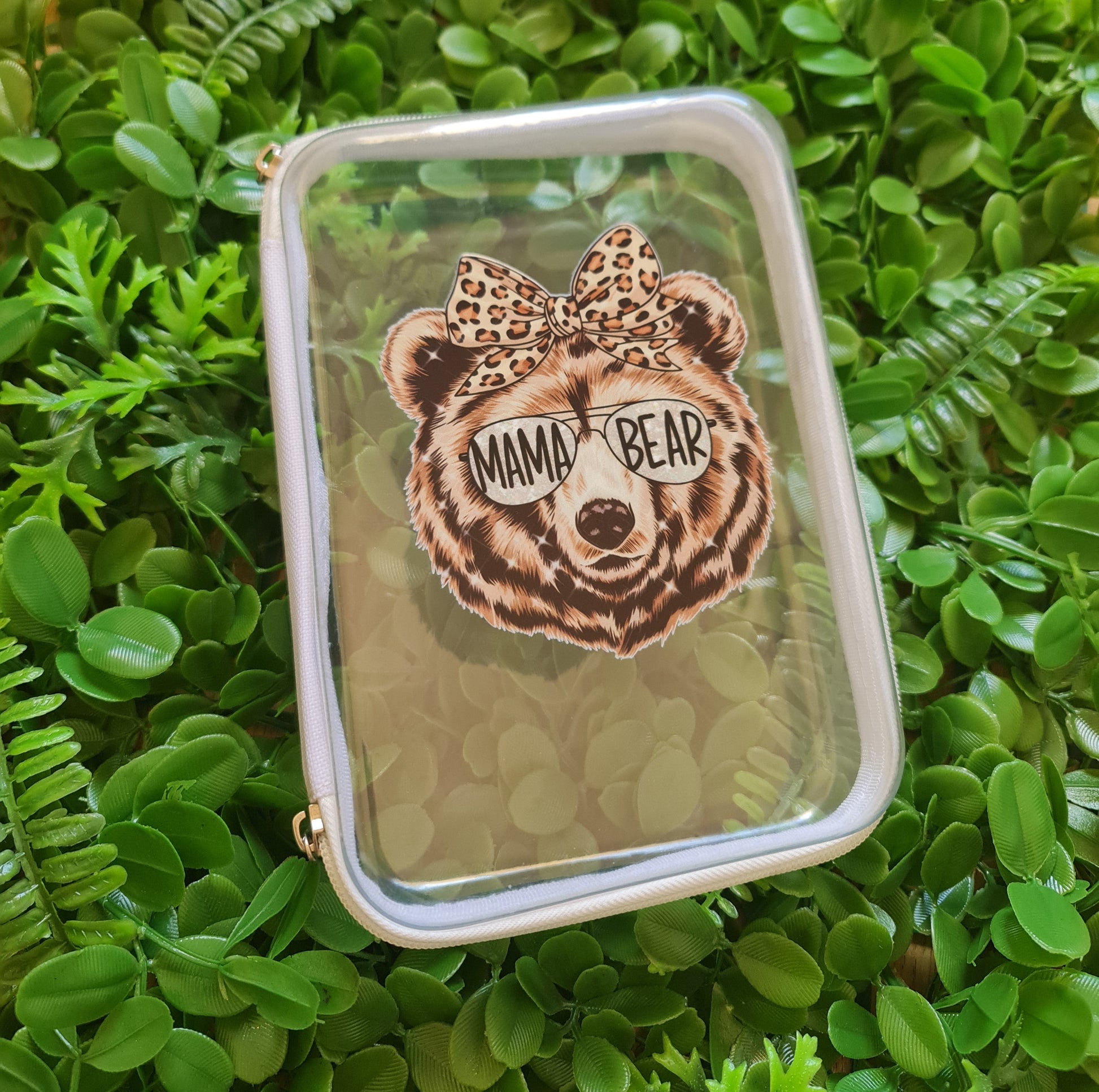 Small rectangular pouch with a leopard print design on a green leafy background